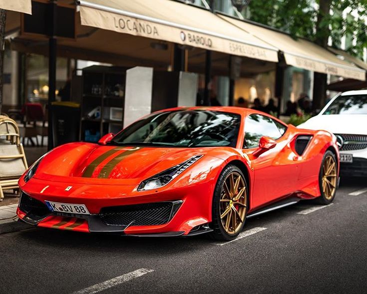 a red sports car is parked on the street