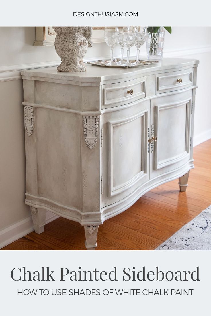 a white painted sideboard with wine glasses on top