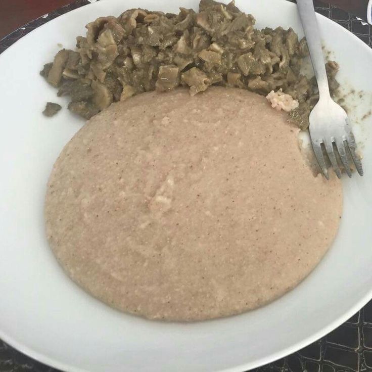 a white plate topped with food next to a fork