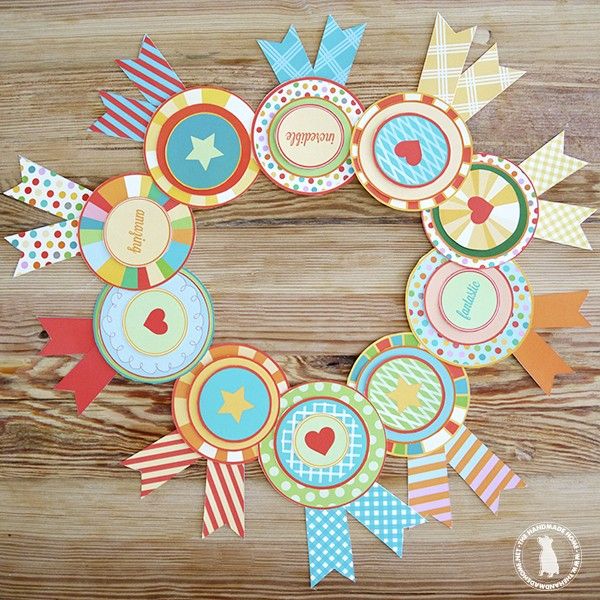 a wreath made out of cupcake toppers on a wooden table