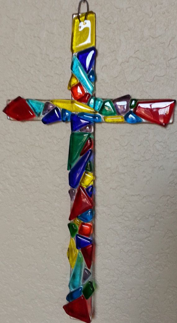 a colorful glass cross hanging on the wall