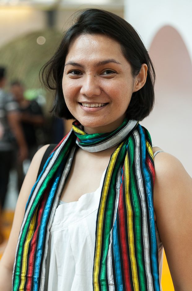 a woman wearing a multicolored striped scarf