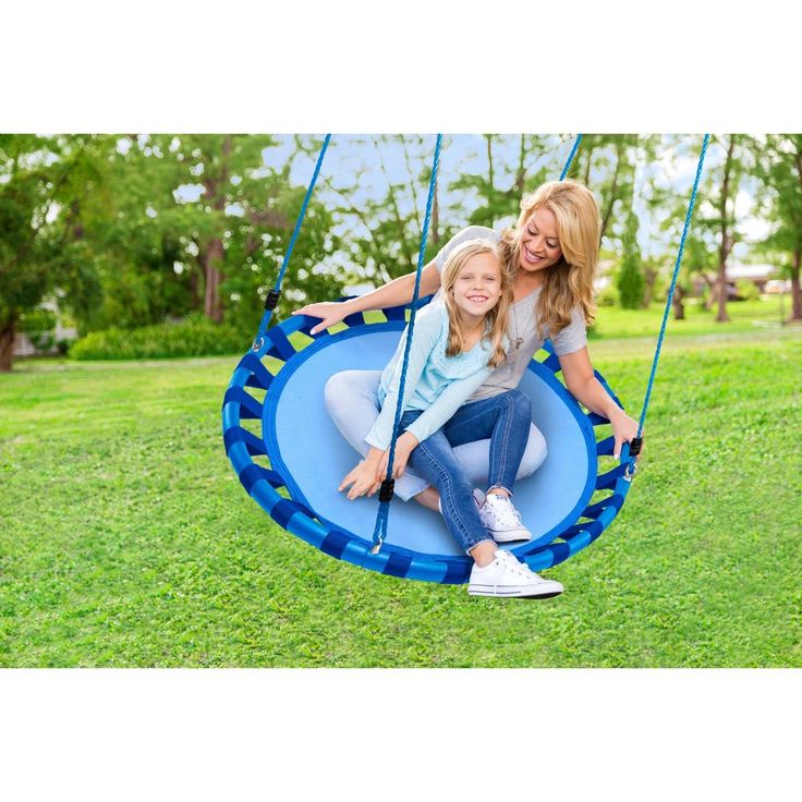 a woman and child sitting on a blue swing