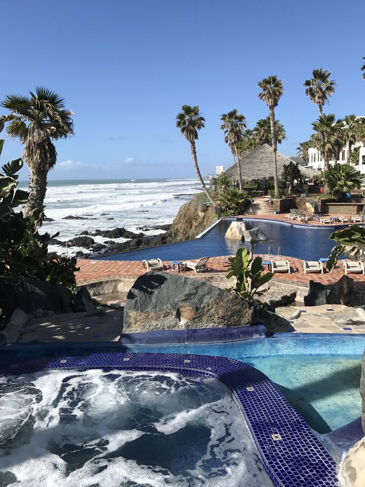 an outdoor hot tub next to the ocean