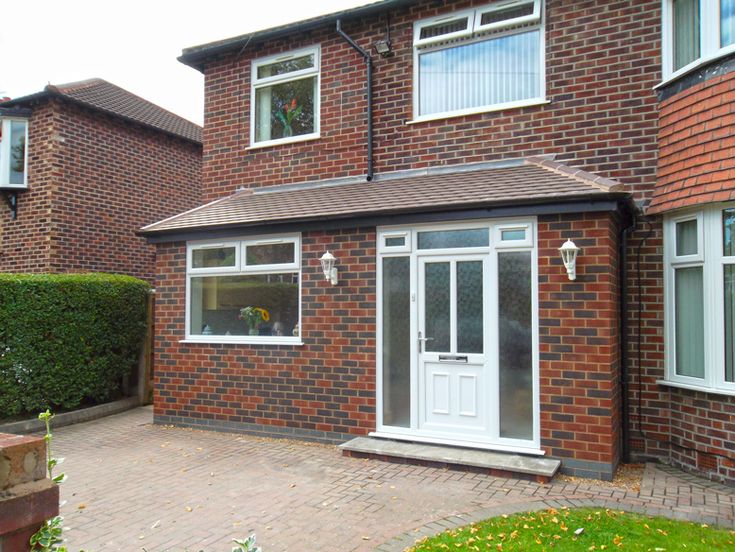 a brick house with white doors and windows