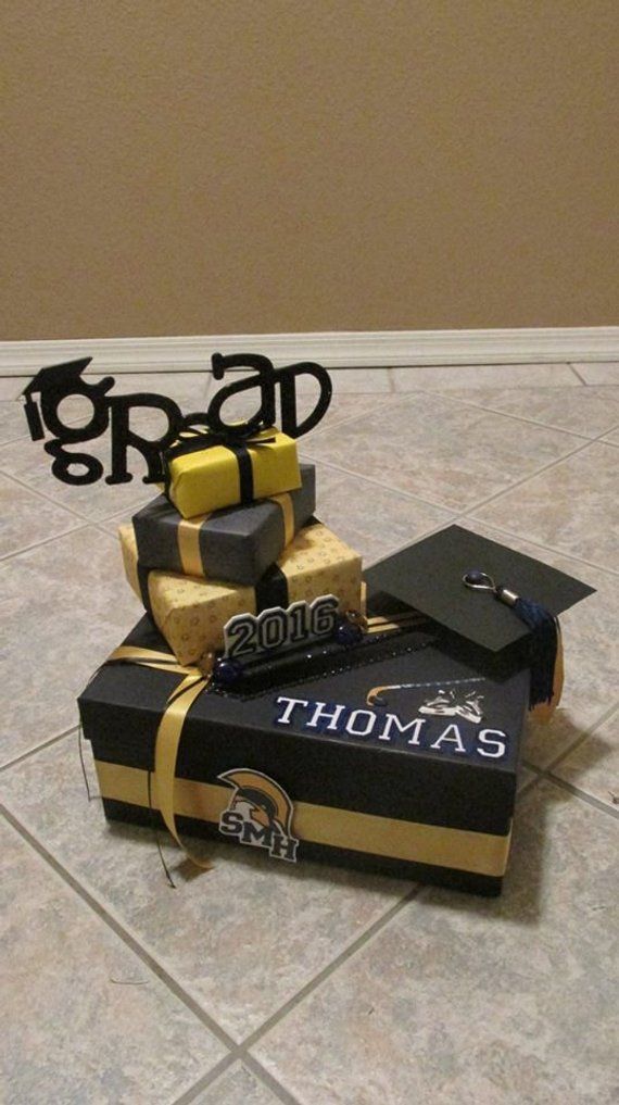 graduation cake made to look like it is stacked on top of each other with congratulations written in black and gold