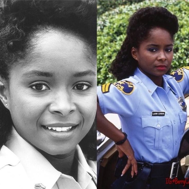 two women in police uniforms one is smiling and the other is posing for a photo