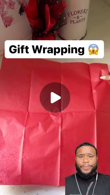 a man is holding up a red bag with the words gift wrapping written on it