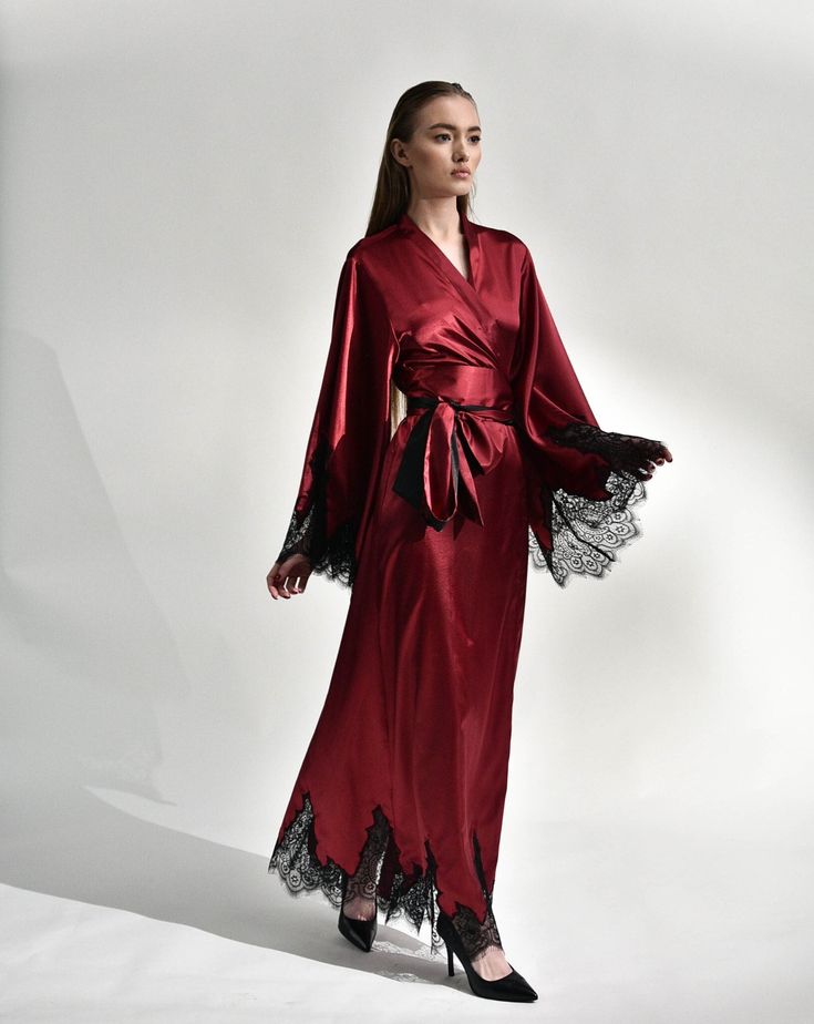 Irresistible in its classic cut, the silk kimono robe with lace embellishments exudes passion. Crafted from silk and satin blend, it features a dramatic, long sweeping hem and draped sleeves, creating a captivating silhouette reminiscent of old Hollywood glamour. The broad obi-style sash draws the waist for a polished profile, making it the epitome of sophistication and a luxurious start to every morning. ✓ garment length - 147 cm/58'' ✓ wrap over style ✓ two sets of inside ties ✓ wide obi-tie i Elegant Satin Kimono With Satin Finish, Elegant Satin Kimono, Luxury Satin Gown, Luxury Wedding Gown With Satin Finish, Evening Kimono With Satin Finish, Evening Kimono With Satin Finish And Kimono Sleeves, Luxury Gown With Satin Finish, Fitted Satin Kimono, Luxury Silk Gown With Satin Finish