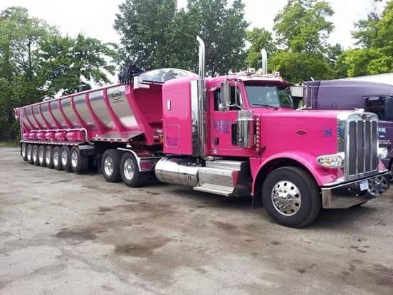 a pink truck parked in a parking lot