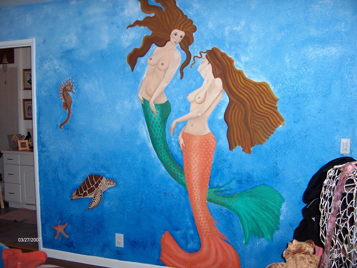 there is a painting on the wall of a mermaid and fish themed room with blue walls