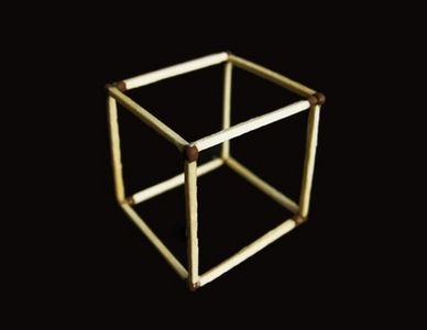 a wooden cube on a black background