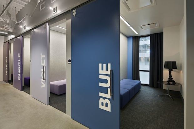 the blue sign is on the wall in the office building's waiting room area