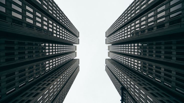 looking up at tall buildings from the ground