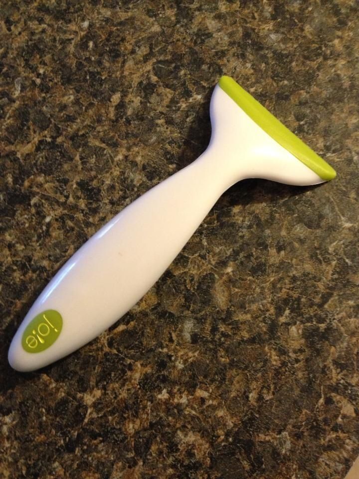 a white and green toothbrush sitting on top of a counter