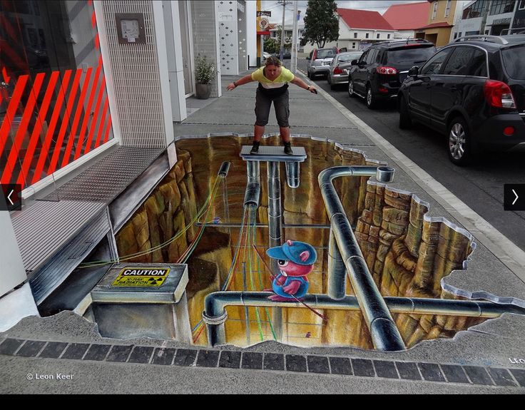 a man standing on top of a skateboard in front of a street art mural