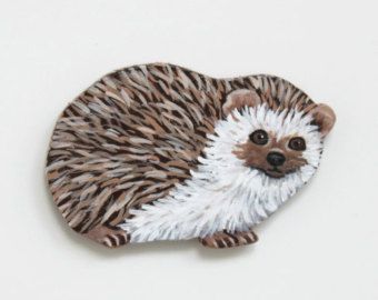 a hedgehog brooch is shown on a white background