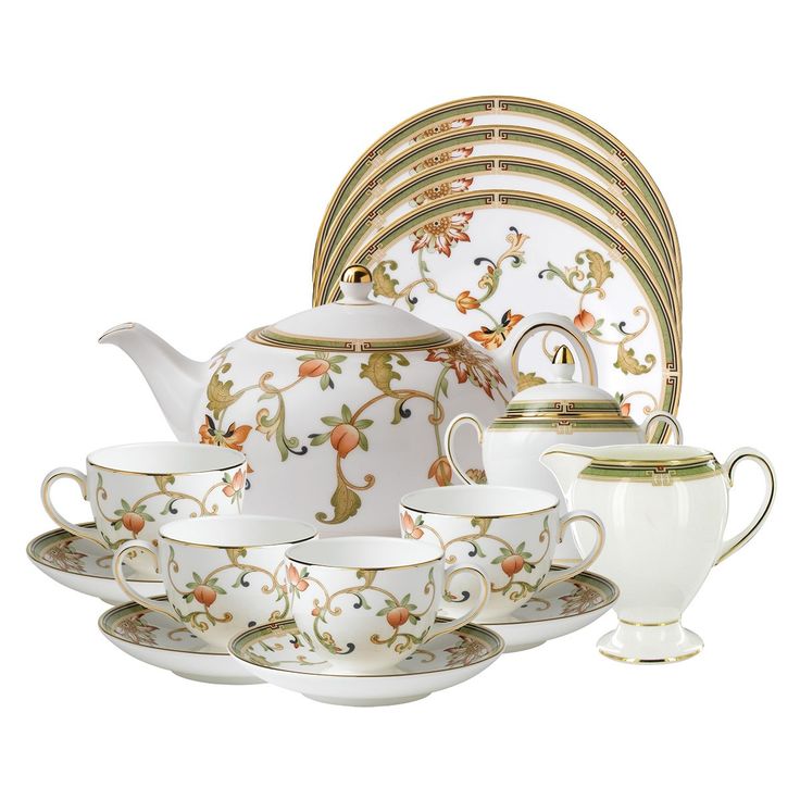 a white and gold china tea set with matching cups, saucers, and plates