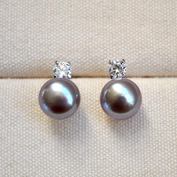 This CLASSIC sterling silver stud earrings are featured with nice unique purple freshwater pearls and sparkling Cubic zirconia stones. It is unparalleled beautiful yet elegant, perfect as a gift for your loved ones on Valentines, Anniversary, Birthday...Details:✦ AAA+ freshwater pearl: natural purple, oblate, approx 9.5-10 mm in diameter, natural white also available at checkout✦ Cubic zirconia stone: approx 4*4 mm✦ Metal: 925 sterling silver✦ Eco-Packaging: beautifully wrapped up inside a padde Silver Akoya Pearl Drop Earrings, Silver Drop Earrings With Akoya Pearl, Fine Jewelry Silver Akoya Pearl Earrings, Delicate Pearl Earrings With Cubic Zirconia For Gift, Delicate Cubic Zirconia Pearl Earrings For Gift, Silver Pearl Earrings With Sparkling Stones For Gift, Silver Akoya Pearl Earrings For Gift, Silver Akoya Pearl Earrings As Gift, Silver Dainty Pearl Earrings With Cubic Zirconia