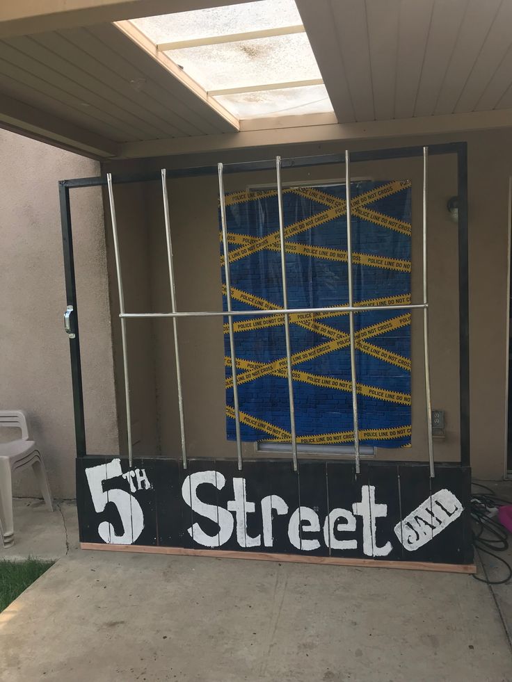 a sign that says 5th street on it in front of a building with metal bars