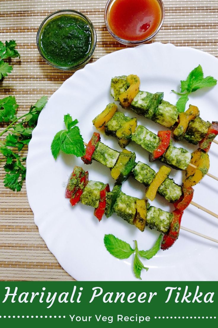 a white plate topped with veggies on top of a wooden table next to dipping sauce