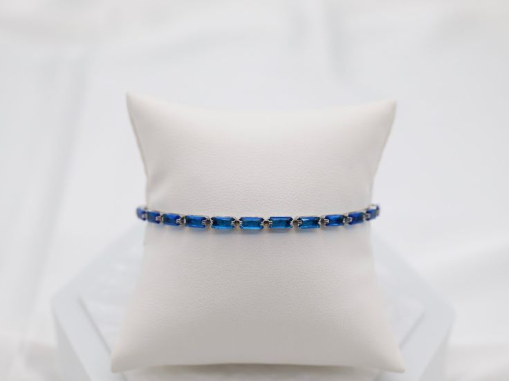 The Navy Blue gemstone adjustable bracelet showcases the mesmerizing beauty of genuine navy blue gemstones, known for their rich blue color and symbolism of renewal and growth. With its adjustable design, this bracelet offers a perfect fit for any wrist while adding a touch of nature's splendor to one's style. Closure: Adjustable Stones: Navy Blue Material: Brass with Silver Plating and Rhodium Coating Lead Free and Hypoallergenic Adjustable Silver Bracelet, Mesmerizing Beauty, Blue Gemstones, The Navy, Tennis Bracelet, Adjustable Bracelet, Rainbow Colors, Silver Bracelet, Perfect Fit