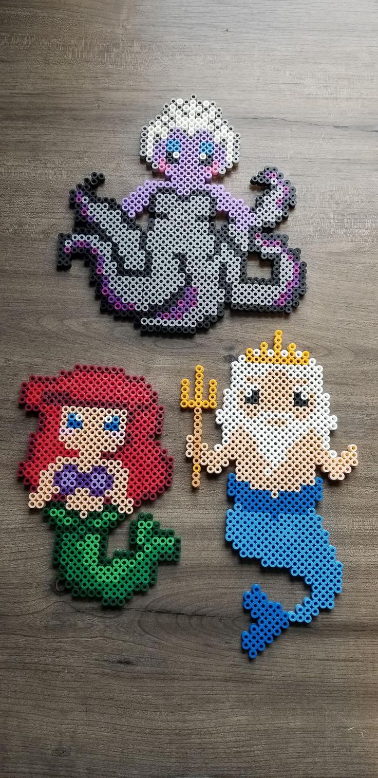 the little mermaids are made out of perler beads and have different designs on them