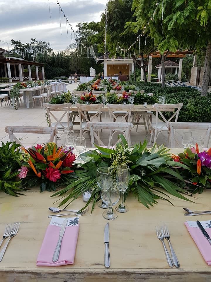 the table is set with flowers and silverware