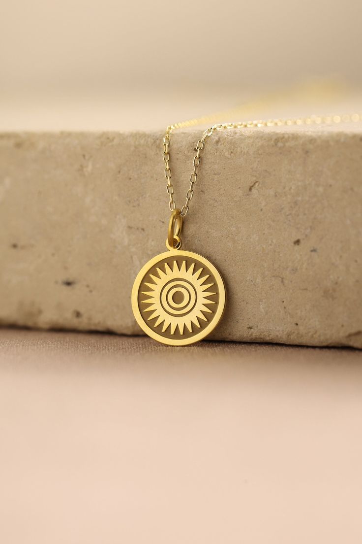 Gold Sun Pendant - Sun Gold Necklace ● Material of pendant: Solid Gold 14k ( REAL GOLD ) ● Metal Stamp: 14k ( REAL GOLD ) ● The pendant is available in 5 sizes: - 12,7 mm / 0.5 inches (Diameter) - 14,0 mm / 0,55 inches ( Diameter ) In the photos - 15,3 mm / 0.6 inches ( Diameter ) - 16,5 mm / 0,65 inches ( Diameter ) - 19,1 mm / 0,75 inches ( Diameter ) ( In the photos the size is 14mm / 0.55 inches Diameter ) ( Jump Ring inner diameter: 4 mm ) ● Material of chain: Solid gold 14k ( REAL GOLD ) I 14k Gold Amulet Charm Necklace With Round Pendant, Yellow Gold Medallion Jewelry As A Gift For Her, Spiritual 14k Gold-filled Yellow Gold Charm Necklace, Spiritual 14k Gold Filled Yellow Gold Charm Necklaces, Yellow Gold Plated Round Charm Necklace, Tarnish Resistant Yellow Gold Charm Necklace For Her, 14k Gold Engraved Amulet Charm Necklace, 14k Stamped Amulet Style Round Pendant Necklace, Spiritual Yellow Gold Charm Necklace For Her