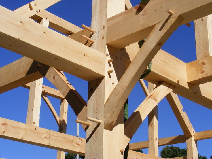 a wooden structure being built with blue sky in the background