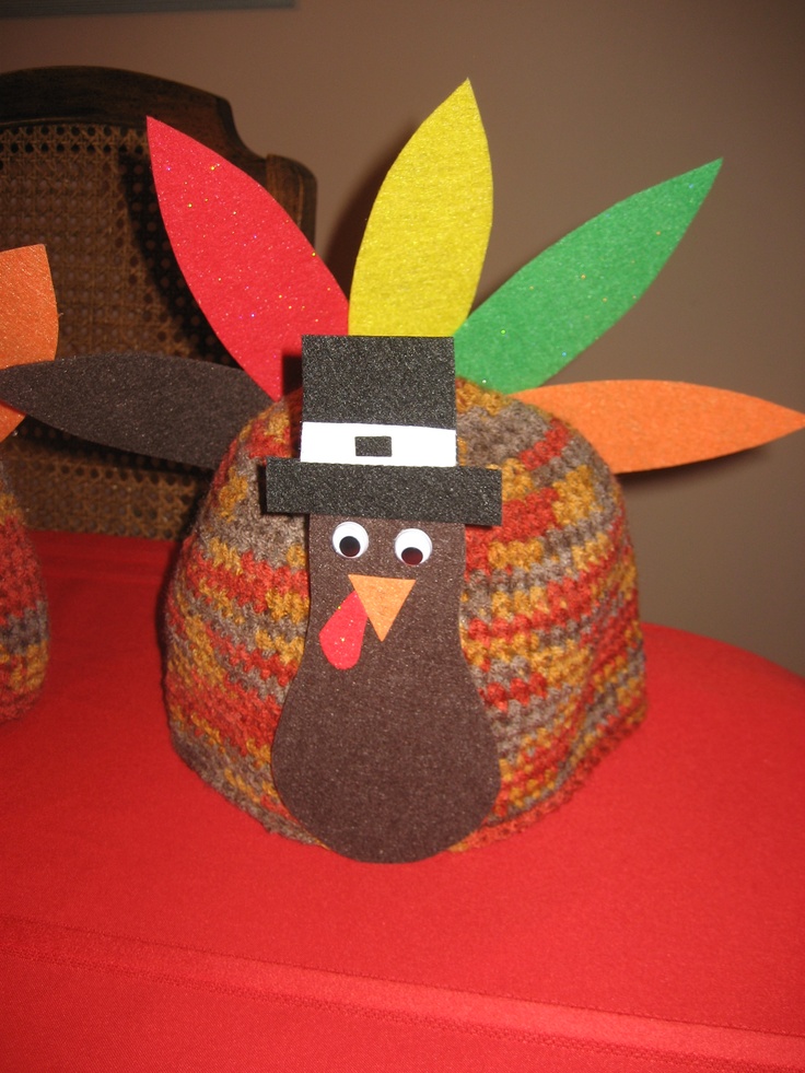 a paper turkey sitting on top of a red table