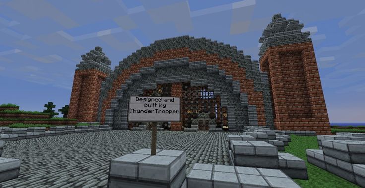 the entrance to an underground minecraft location, with a sign in front of it