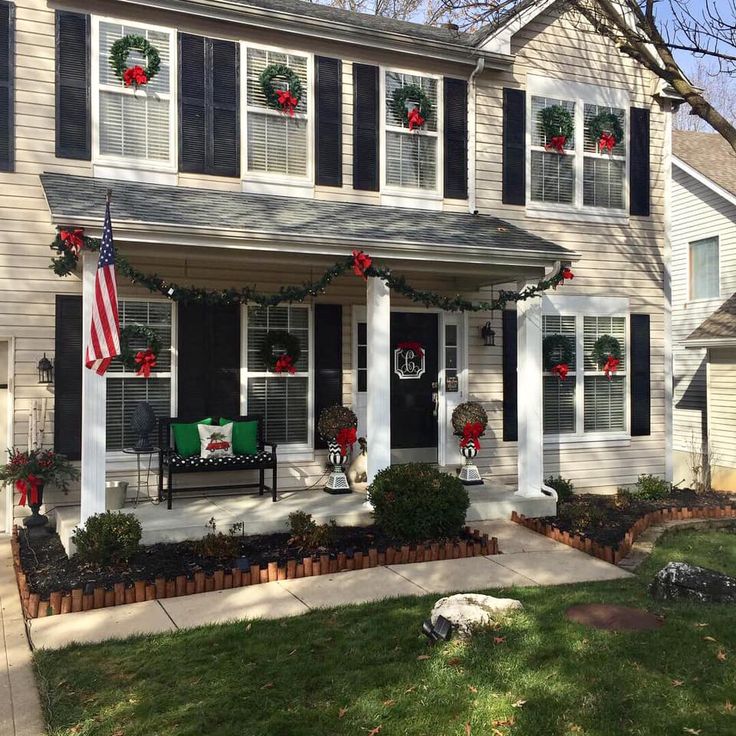 a house decorated for christmas with wreaths and decorations