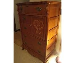 a wooden dresser with carvings on the drawers