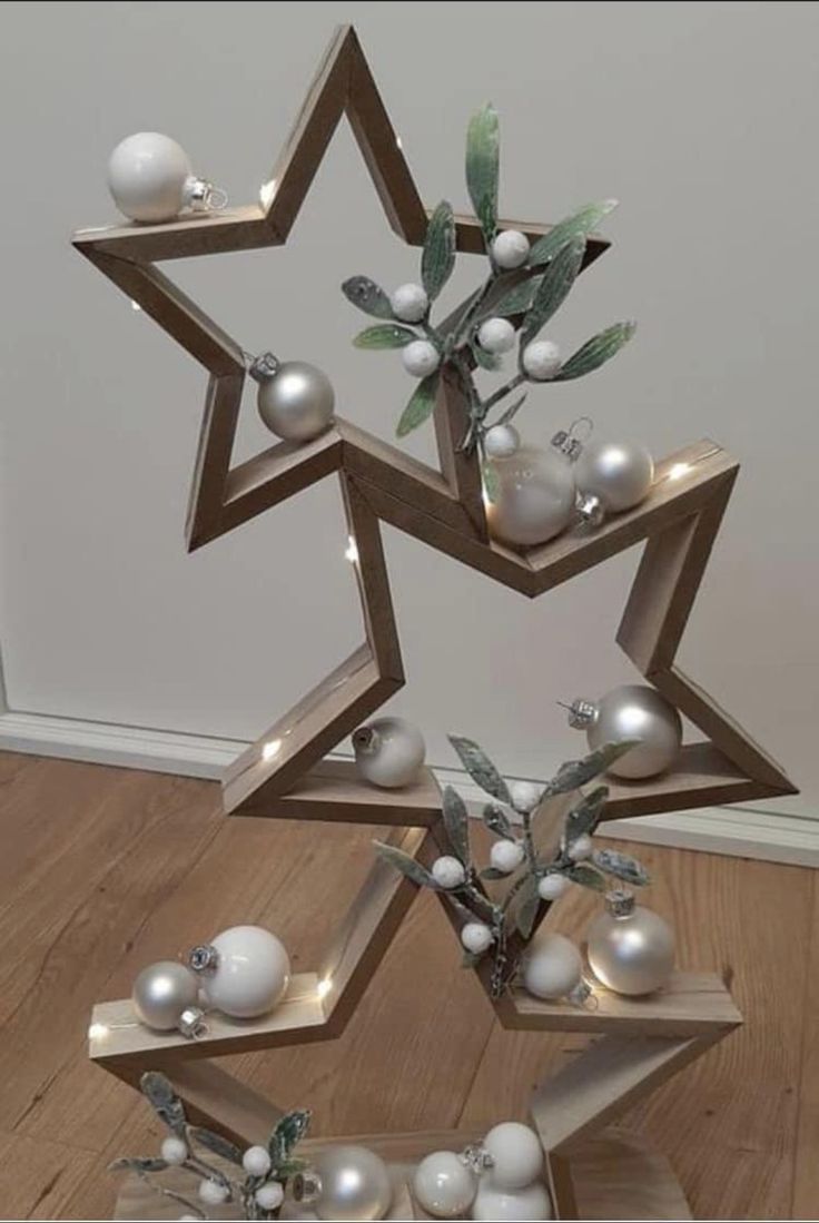 a christmas tree made out of wooden blocks with ornaments on it and lights in the shape of stars