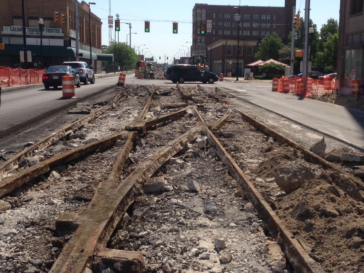 an old train track laying on the side of the road