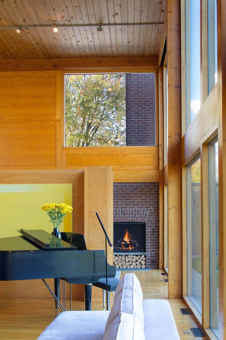 a living room filled with furniture and a fire place in front of a large window