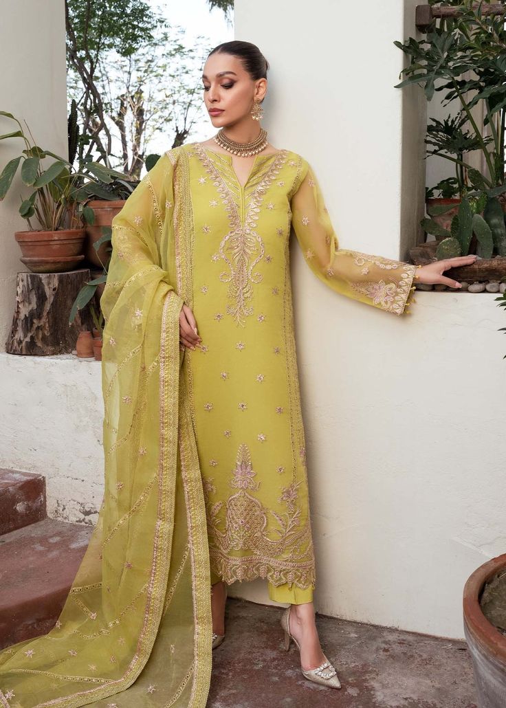 Yellow Embroidered luxury Pakistani Salwar Kmaeez Dupatta Suit is a stunning dress to wear on a festive occasion. This beautiful Kameez Trouser is emblazoned with embroidery, floral designs, motifs, gotta, and mirror details, making it an epitome of beauty and grace. Chiffon Kameez: The kameez has a beautiful blend of green and grey colors. The premium chiffon fabric and hand-crafted details of embroidery make it a chic choice for the big day. Mirror details on the neckline and gota details give Festive Chinon Churidar With Chikankari Embroidery, Semi-stitched Pista Green Organza Dress, Pista Green Semi-stitched Organza Dress, Designer Dresses With Chikankari Embroidery For Diwali, Unstitched Anarkali Set For Eid Party, Chanderi Dress With Chikankari Embroidery For Eid, Designer Chikankari Embroidery Dress For Diwali, Gold Georgette Dresses For Eid, Pista Green Dress With Resham Embroidery For Eid