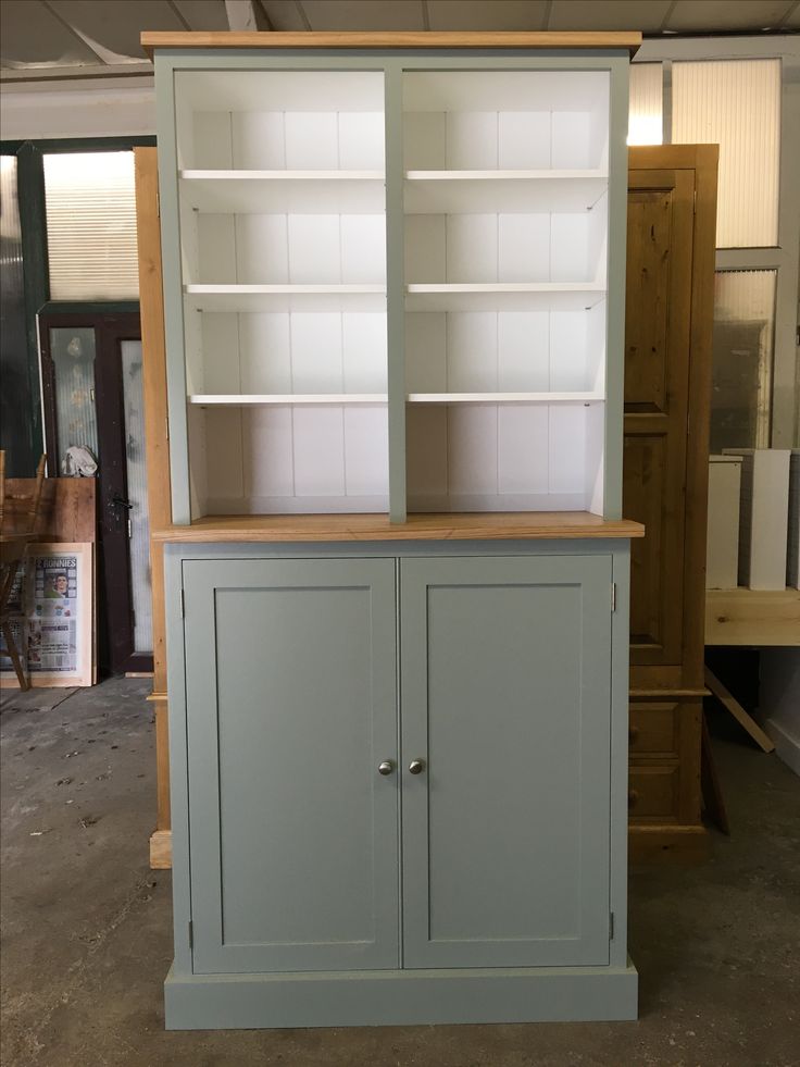 a large bookcase with two doors and shelves