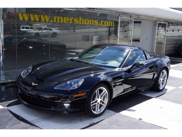 a black sports car parked in front of a store