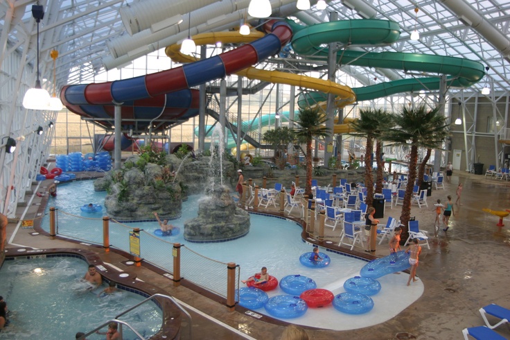 an indoor water park with slides and swimming pool