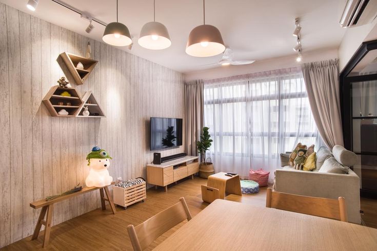 a living room filled with furniture and a flat screen tv sitting on top of a wooden table