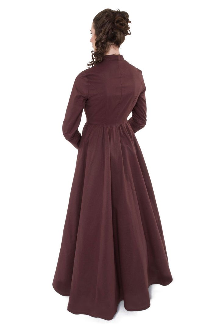 "Experience the fashion of centuries past wearing this cotton dress - a true Victorian cut. From a very young age, this is what our designer would often envision when thinking of classic \"Victorian fashion.\" From the tailored fit of the straight cut bodice to the modest high collar neckline and long tapered set sleeves, this dress is perfect! The graceful four-paneled skirt is full enough to accommodate a hoop or petticoat. Front button closure with metal button accents. What a delightful dres Elegant Cotton A-line Vintage Dress, Fitted Victorian Historical Dress, Fall Dresses With Historical Design, Classic Fitted Victorian Dress With Buttons, Classic Vintage A-line Dress With Fitted Bodice, Historical Design Fitted Cotton Dress, Fitted Victorian Cotton Prairie Dress, Historical Victorian Dress With Buttons, Long Sleeve Cotton Dresses With Historical Design