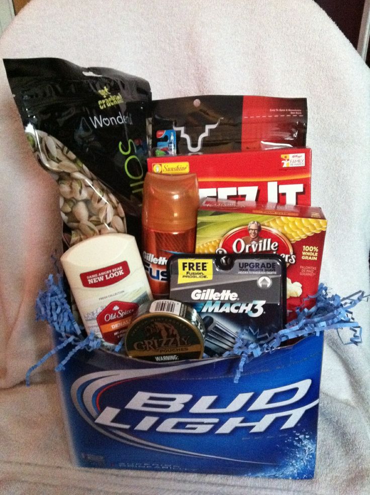 a bag filled with snacks and condiments sitting on top of a bed