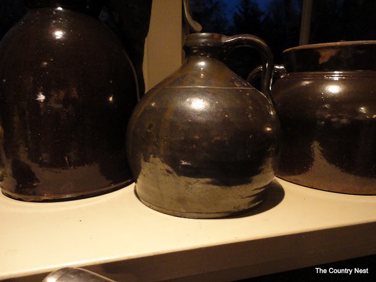 three metal pots sitting on top of a white counter next to a window sill