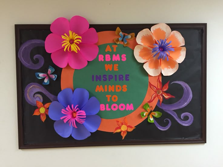 there is a sign with flowers on it that says at rooms we inspire minds to bloom