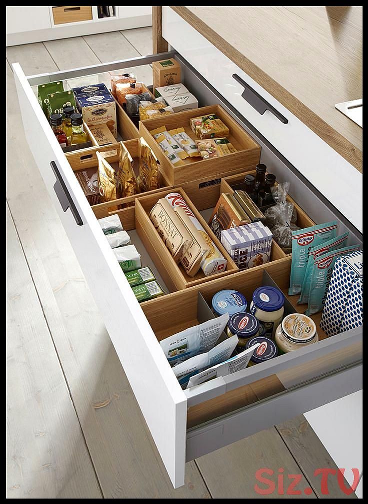 an open drawer in a kitchen filled with food