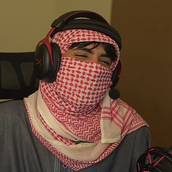 a man with headphones and a scarf covering his face