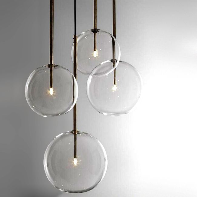 three clear glass orbs hanging from a ceiling