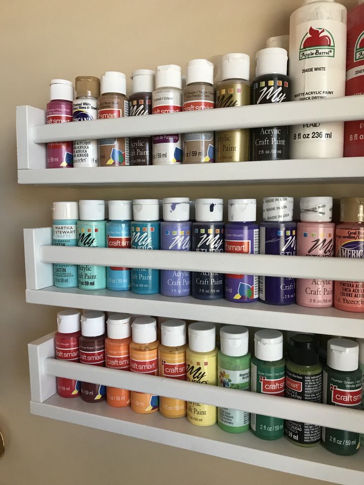 the shelves are filled with many different types of paint